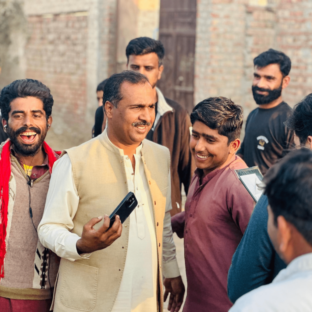 Rana Iqbal Siraj smiling with Children and People